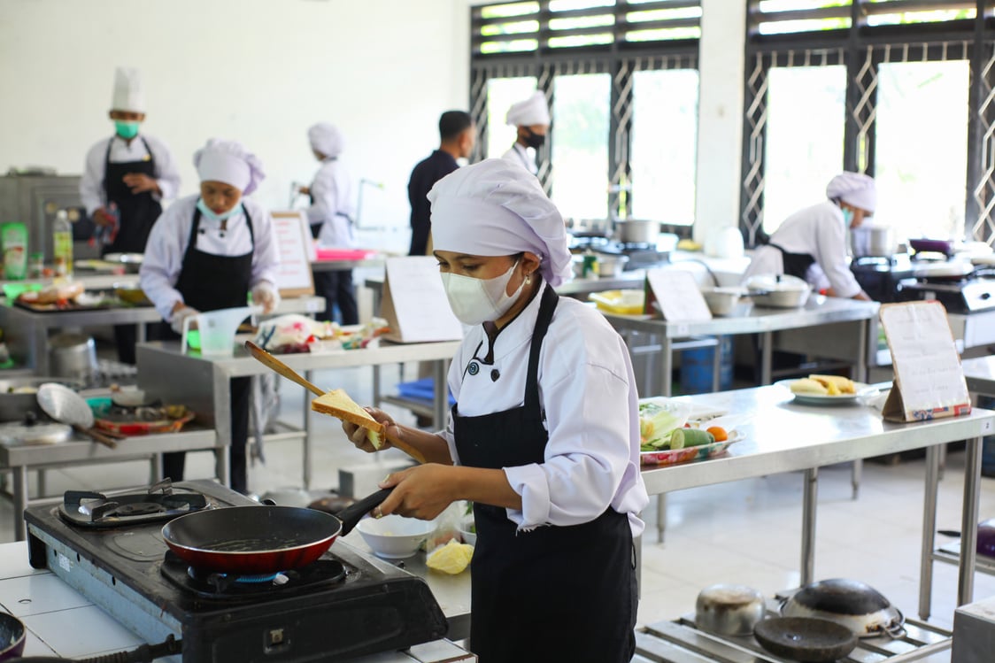 Chefs Cooking in a Kitchen while Wearing Face Masks